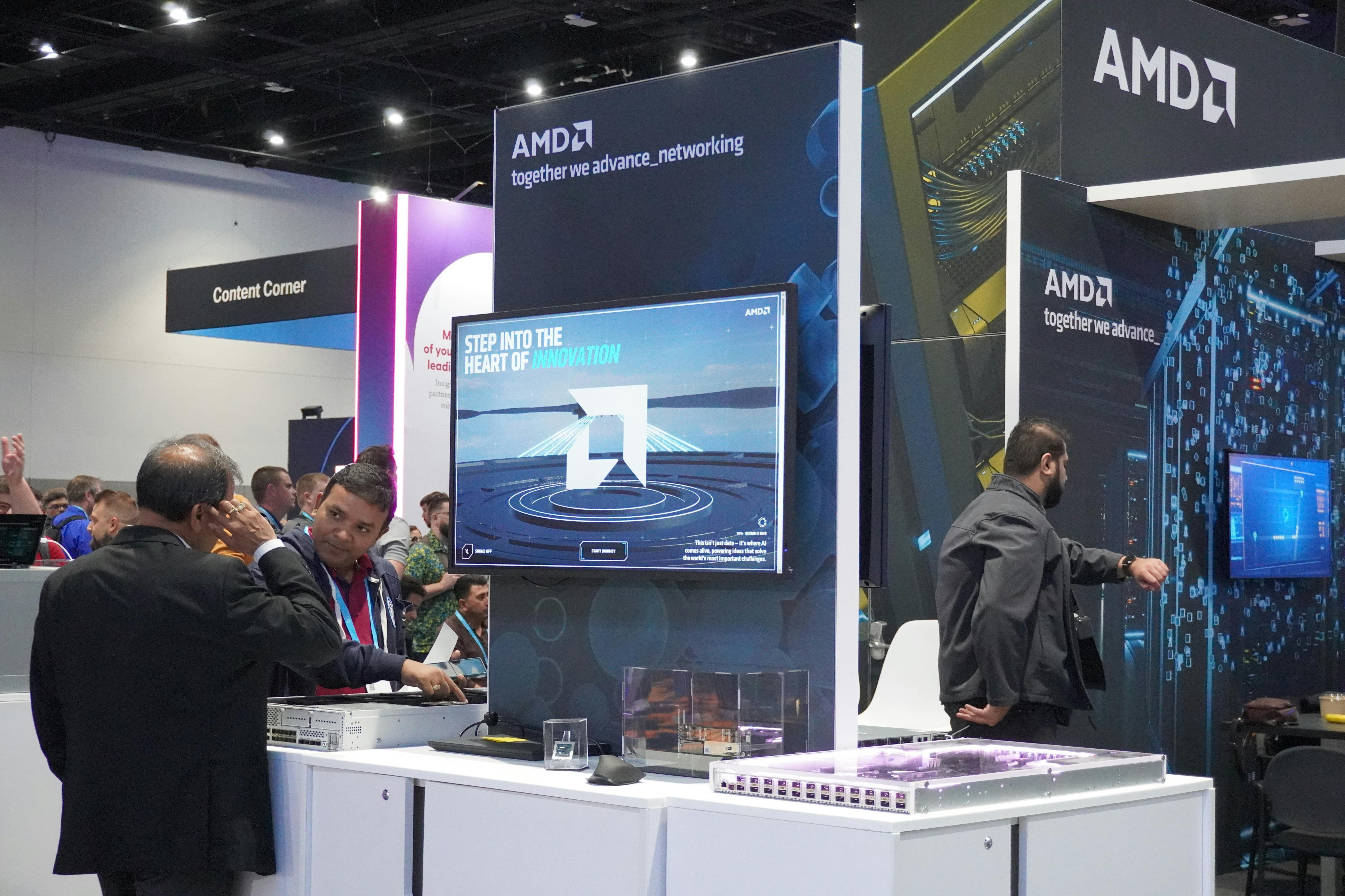 Large-scale event screen displaying AMD AI Factory interactive experience at technology conference
